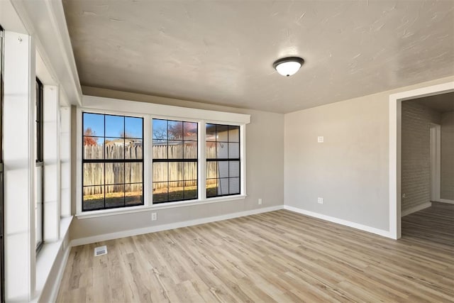 spare room with light wood-type flooring