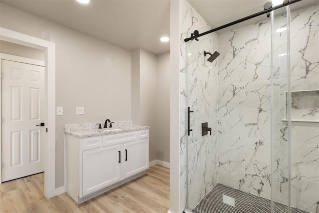 bathroom featuring vanity, hardwood / wood-style flooring, and an enclosed shower