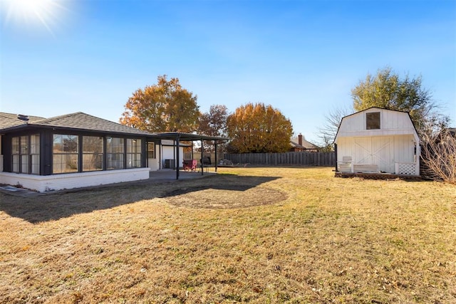 view of yard featuring a sunroom, a shed, and a carport