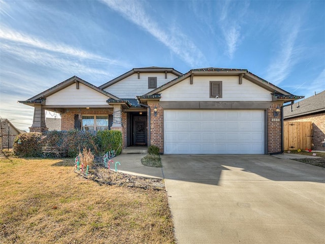 view of front of home with a garage and a front lawn