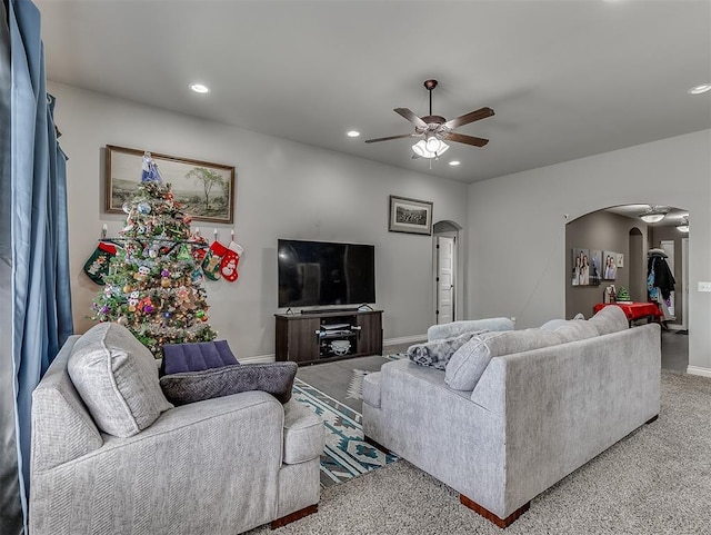 carpeted living room featuring ceiling fan