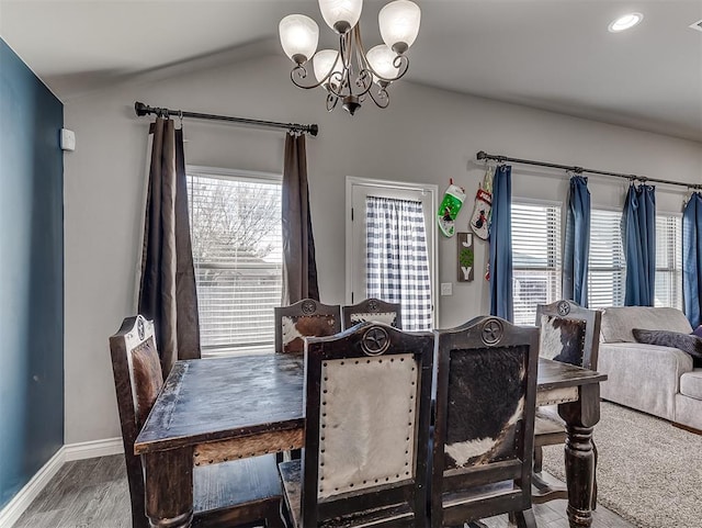 dining space with a chandelier, wood-type flooring, and a wealth of natural light