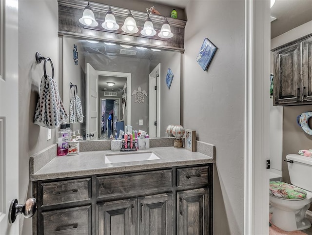 bathroom featuring vanity and toilet