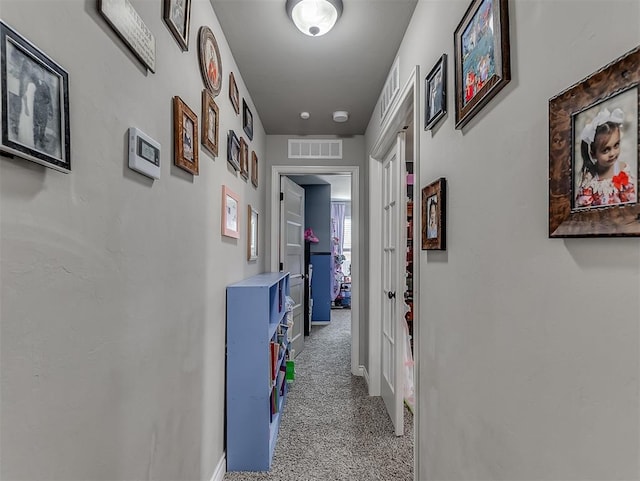 corridor with light colored carpet