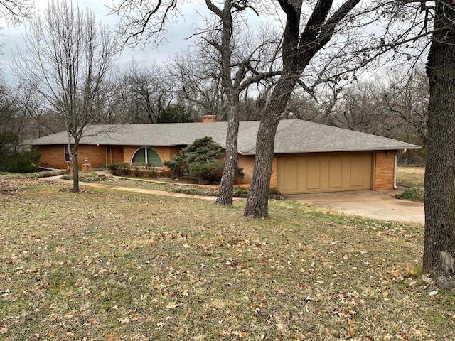 ranch-style home featuring a front yard and a garage