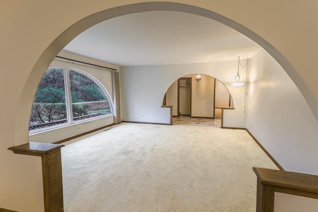 unfurnished living room with light colored carpet