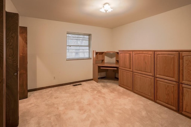 unfurnished bedroom featuring light carpet