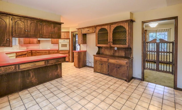 kitchen with white appliances and light tile patterned floors