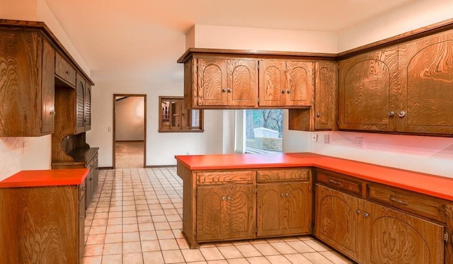 kitchen featuring kitchen peninsula and light tile patterned floors