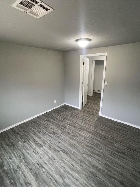 empty room with dark wood-type flooring