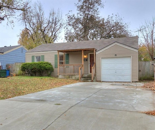 single story home featuring a porch and a garage