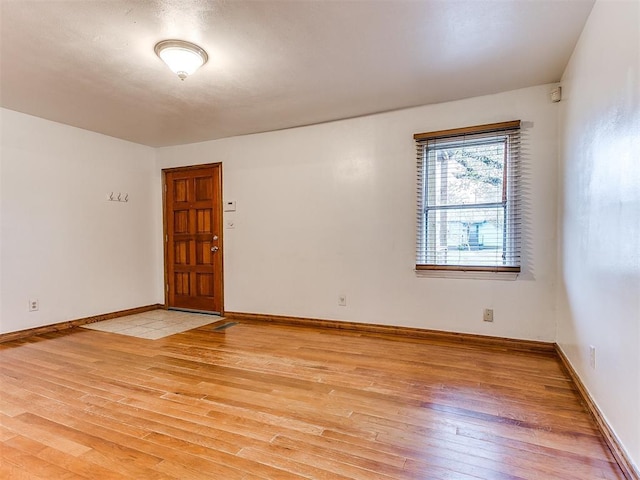 spare room with light hardwood / wood-style flooring