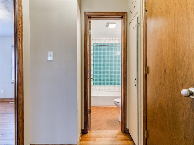 corridor with light wood-type flooring