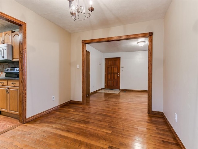 interior space featuring wood-type flooring and a chandelier