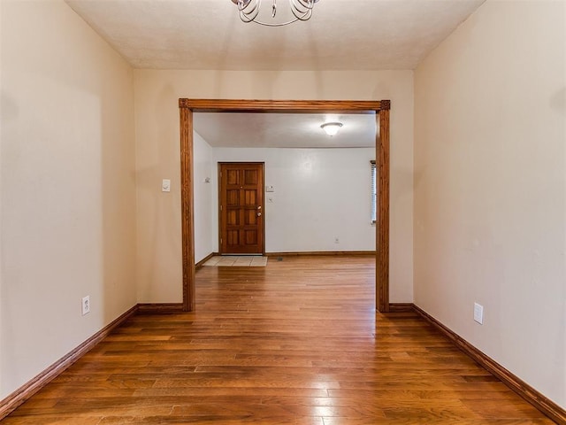 hallway with light hardwood / wood-style floors