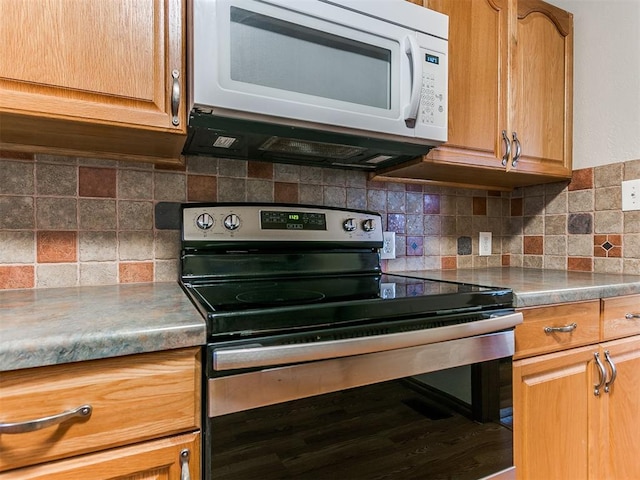 kitchen featuring stainless steel electric range, wood-type flooring, and backsplash