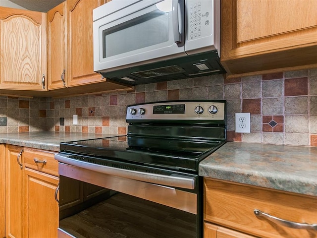 kitchen featuring stainless steel electric stove and decorative backsplash