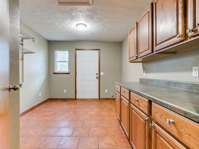 kitchen featuring light tile patterned floors and a textured ceiling