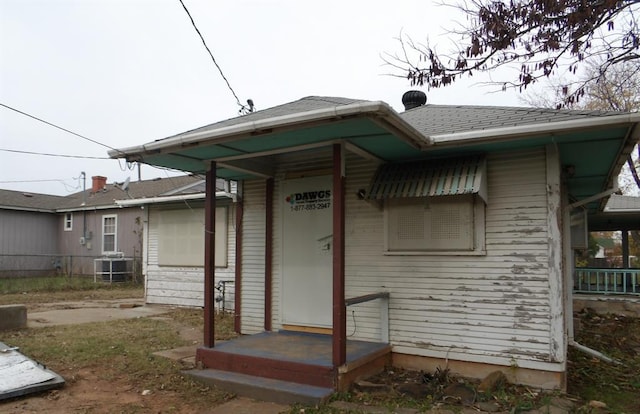 back of house with central air condition unit