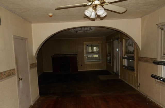 hallway featuring a textured ceiling, crown molding, and dark hardwood / wood-style floors