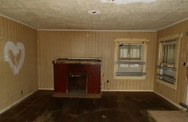 unfurnished living room with a fireplace, a textured ceiling, and dark hardwood / wood-style floors