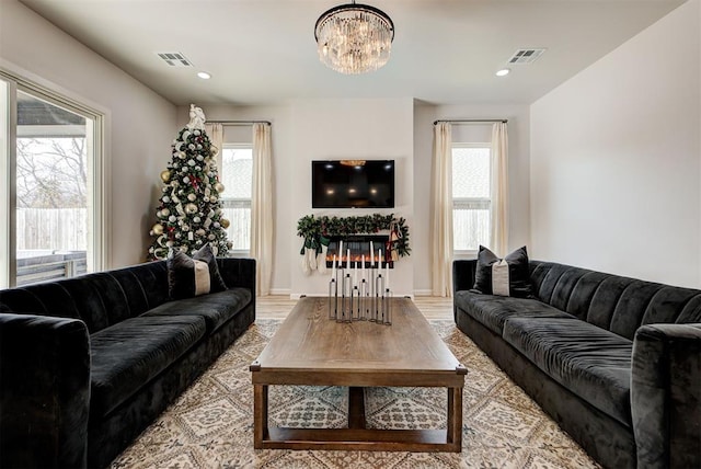 living room featuring an inviting chandelier and light hardwood / wood-style flooring