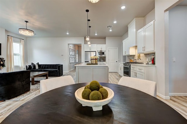 dining room with a notable chandelier and light hardwood / wood-style flooring