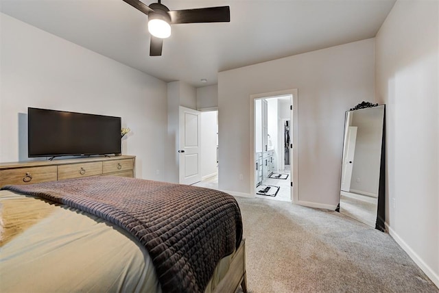 carpeted bedroom with ensuite bath and ceiling fan