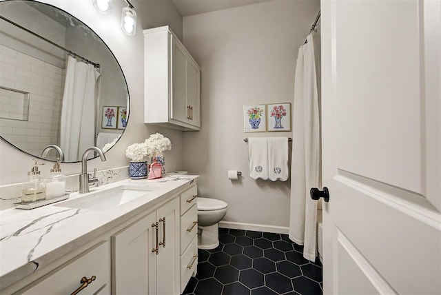 bathroom with toilet, vanity, tile patterned floors, and walk in shower