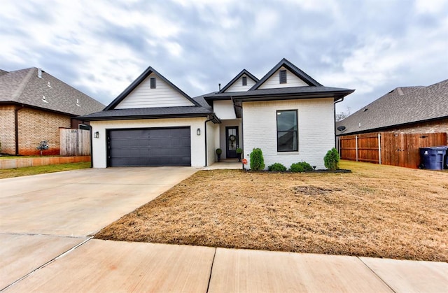 view of front of property with a front yard and a garage