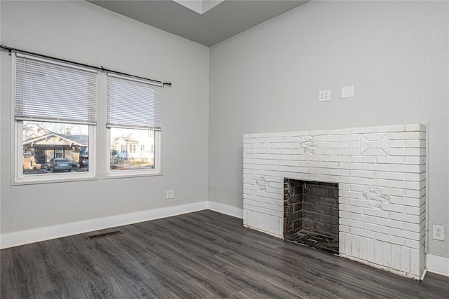 unfurnished living room with a fireplace and dark wood-type flooring