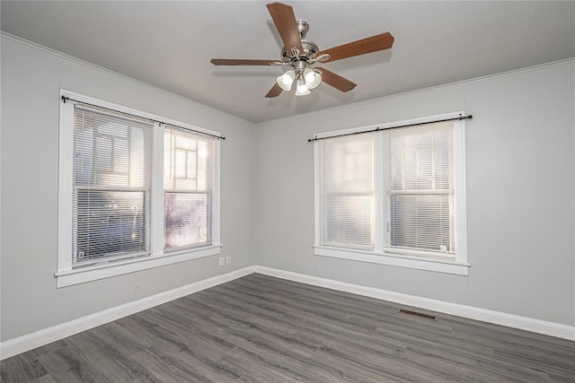 unfurnished room featuring crown molding, ceiling fan, and dark wood-type flooring