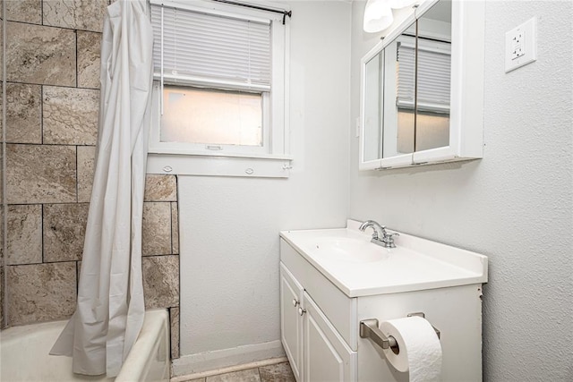 bathroom featuring shower / bath combo and vanity