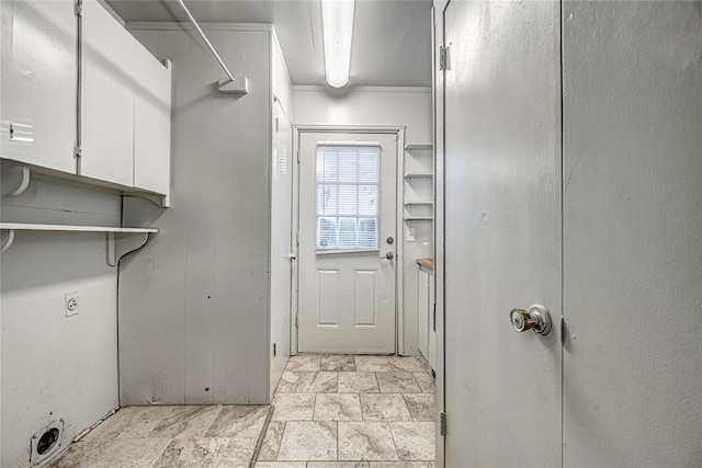 laundry room featuring electric dryer hookup and cabinets