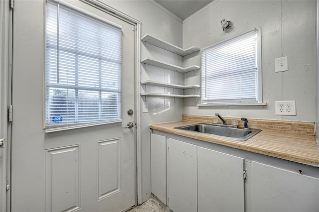 kitchen with white cabinetry and sink