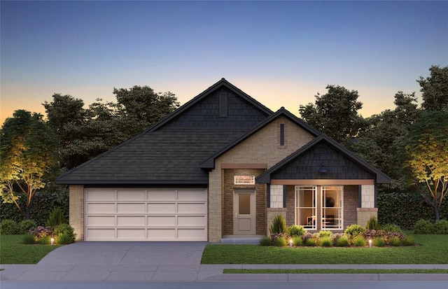 view of front of house with a garage and a lawn