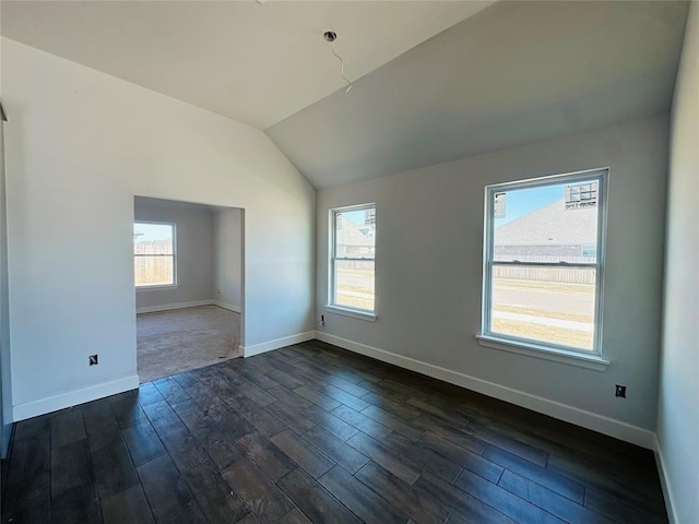 empty room with baseboards, lofted ceiling, a healthy amount of sunlight, and dark wood-style flooring