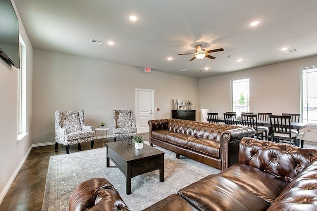 living room featuring visible vents, a ceiling fan, recessed lighting, baseboards, and concrete flooring