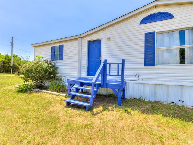 rear view of house with a yard