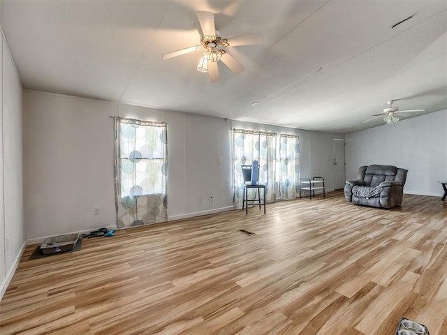 unfurnished room with ceiling fan and light wood-type flooring