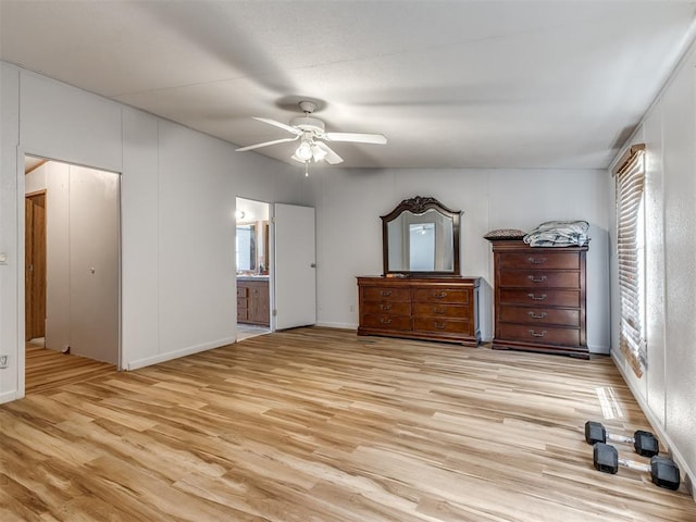 unfurnished bedroom featuring light wood-type flooring, ceiling fan, and connected bathroom