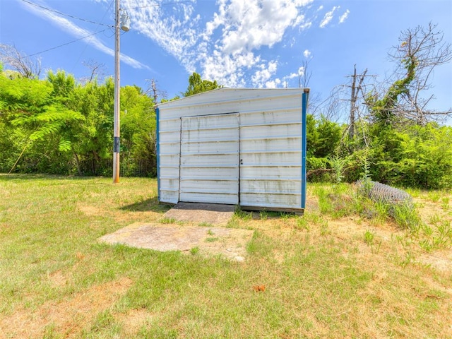 view of outbuilding with a lawn