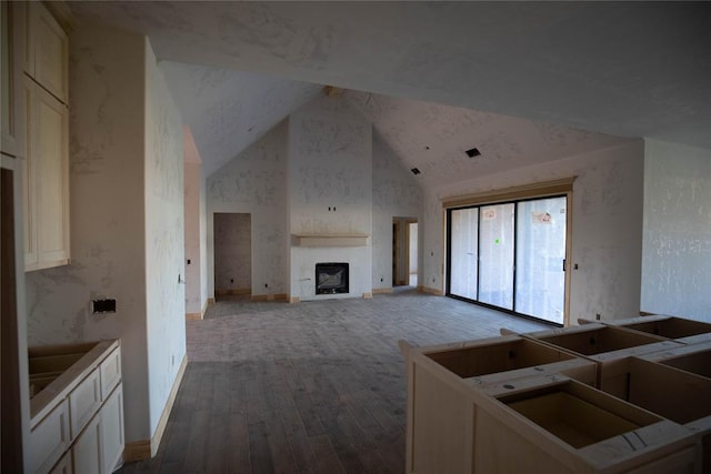 5800 Lantana Ln, Edmond, OK 73034 - kitchen with a fireplace, vaulted ceiling, wood-type flooring, and baseboards