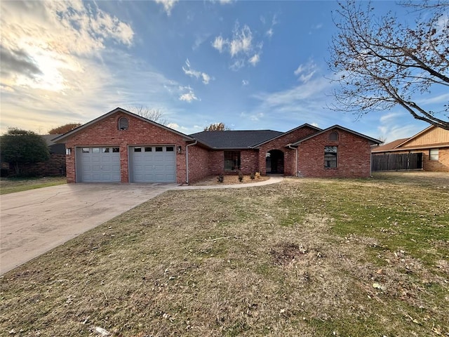 ranch-style home with a garage and a front lawn