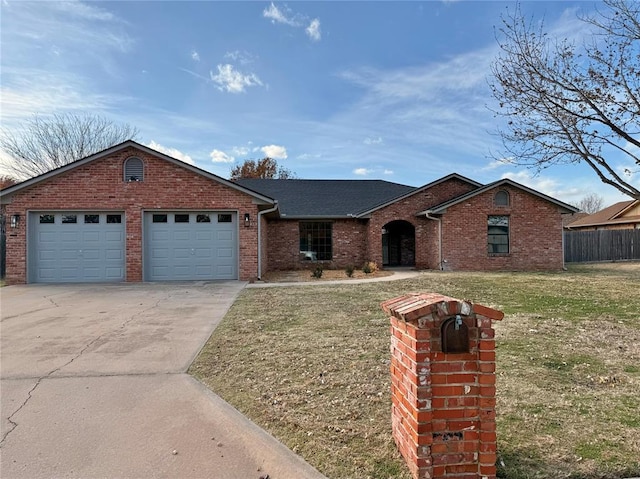 ranch-style house featuring a garage and a front lawn