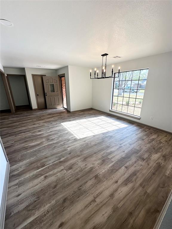 interior space featuring hardwood / wood-style flooring and an inviting chandelier