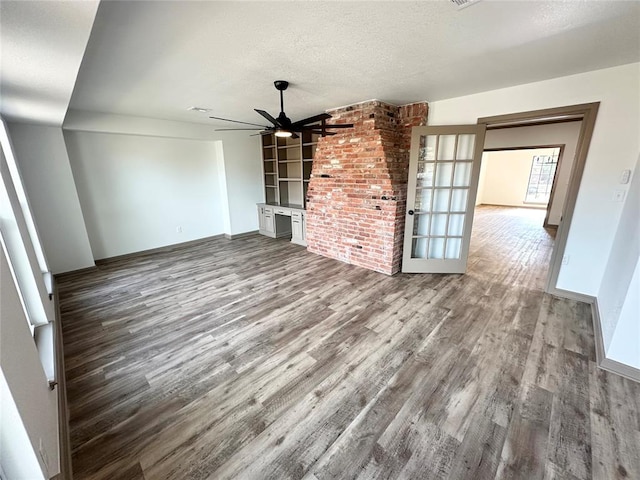 unfurnished living room featuring hardwood / wood-style floors, a textured ceiling, and ceiling fan