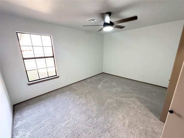 empty room with carpet flooring and ceiling fan