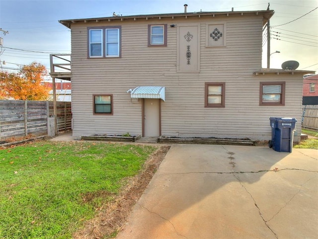 rear view of property with a lawn