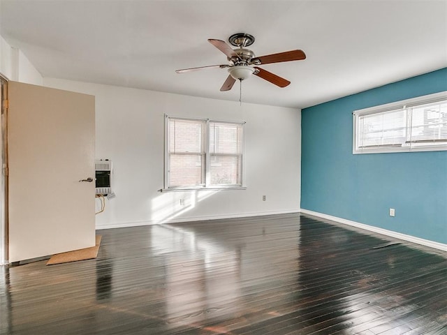 unfurnished room with ceiling fan, plenty of natural light, and dark wood-type flooring